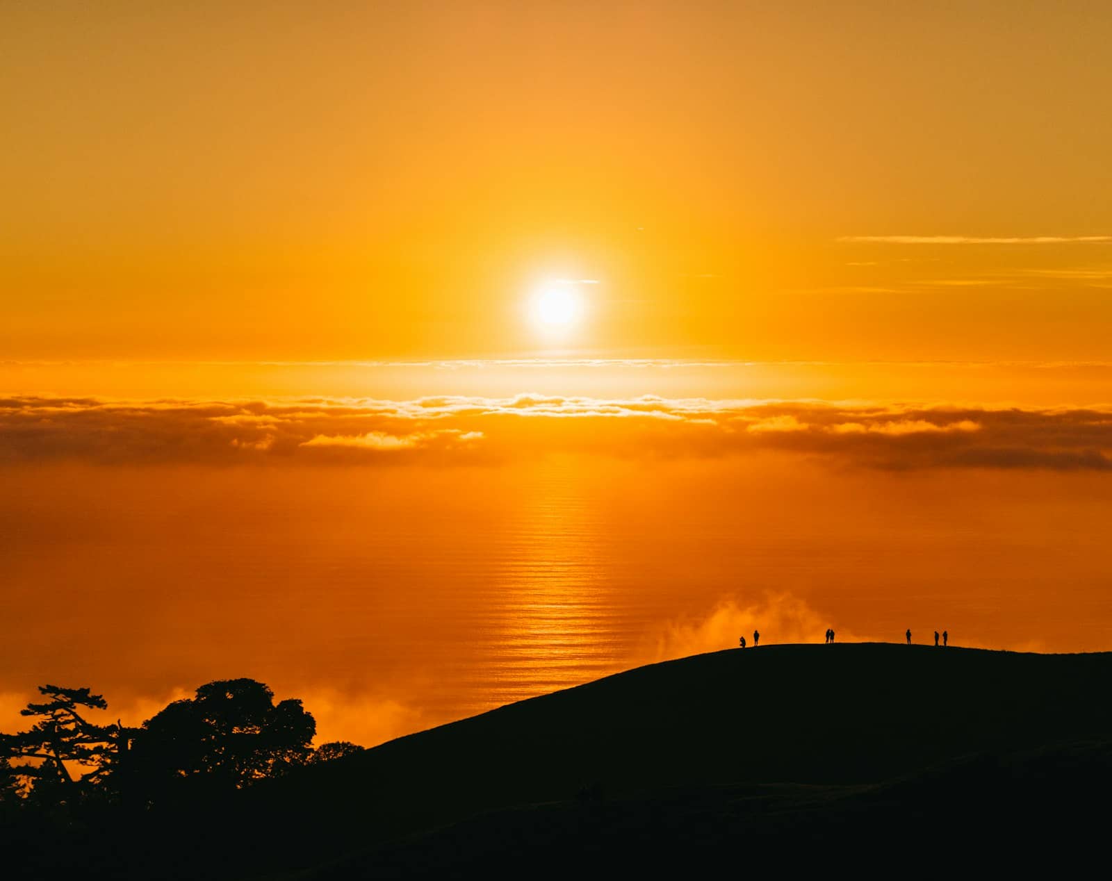 Orange sky at sunrise over a hill station