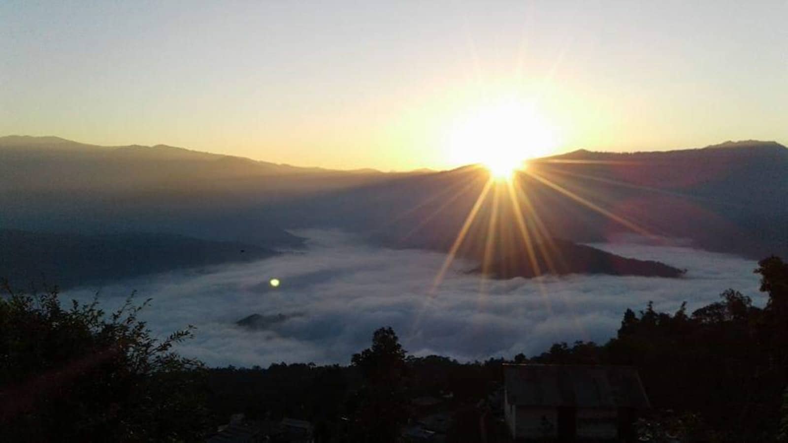 Sunrise over a valley of clouds